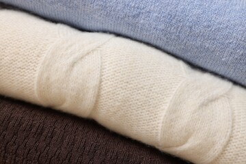 Closeup view of different warm folded sweaters as background