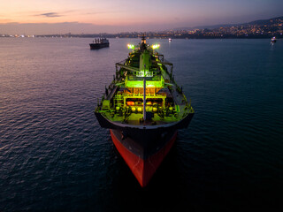 A massive cargo ship wood chips carrier in the sea, aerial view