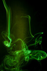 Green smoke motion on black background. - 692937868