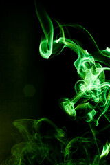 Green smoke motion on black background. - 692937885