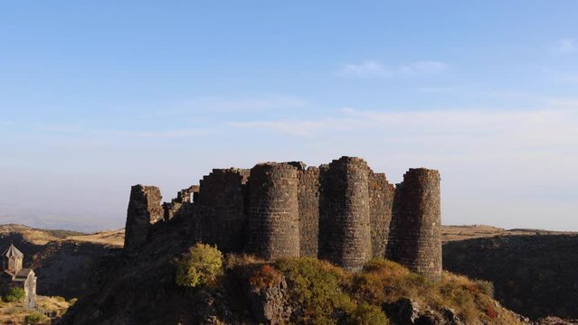 Amberd fortress, Vahramashen church, and the Armenian flag captured with a moving camera during the golden hour on a clear autumn day, uhd, 4k, 3840, 2160