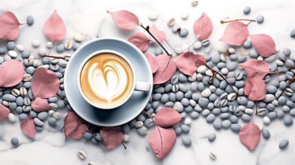 Light blue cup of cappuccino from above with latte art, dried pink leaves and grasses, on a slate...