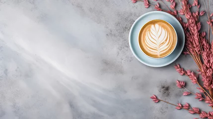 Light blue cup of cappuccino from above with latte art, dried pink leaves and grasses, on a slate stone, coffee beans, isolated on a white background. © beoyou