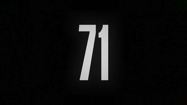 The number 71 smolders and burns on a black background, the number is on fire