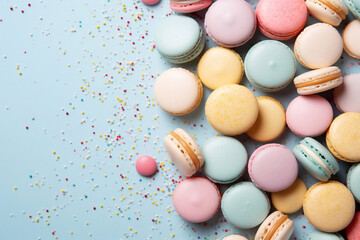 Fototapeta na wymiar Top view of colorful cookies, French Macarons on a pastel blue background with beautifully scattered confetti