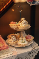 Sweet cake baskets with fluffy cream on a two-tier stand