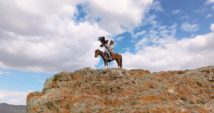 Eagle Hunter At The Top Of Cliff In Western Mongolia - Drone Shot