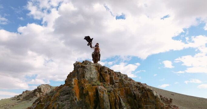 Eagle Hunter On Horse Preparing The Eagle To Fly In Western Mongolia. - aerial orbit shot