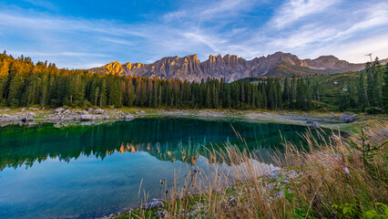 Lago di Carezza, emerald waters, mystical Spruce forests, Latemar mountain views. A picturesque gem in South Tyrol and the Dolomites' favorite