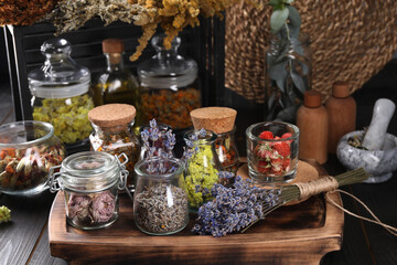 Many different herbs and dry lavender flowers on wooden table