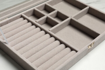 Empty light grey jewelry box on white table, closeup