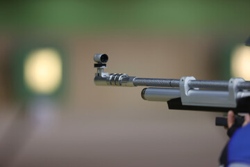 An air rifle in close-up. Target shooting in the shooting range. - obrazy, fototapety, plakaty