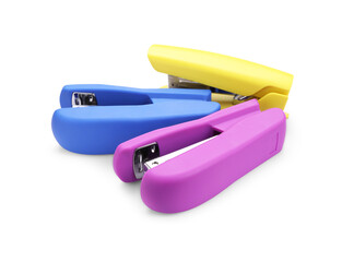 Many new bright staplers isolated on white