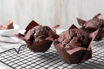 Tasty chocolate muffins on grey table, closeup