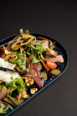Healthy beef salad with vegetables and fruits.