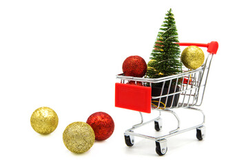 Artificial toy christmas tree and Christmas tree toys in supermarket grocery shopping cart isolated...