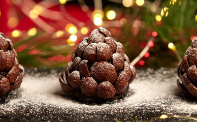Handmade chocolate sweet dessert cake in the shape of a spruce or pine cone. Holiday baking and...