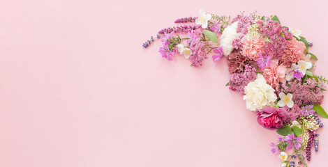 Fototapeta na wymiar beautiful summer flowers on pink paper background