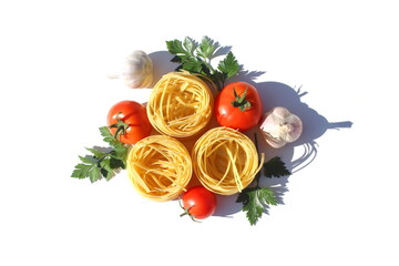 Three spaghetti in the form of a nest with vegetables lie on a white background.