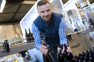 portrait of male worker in wine bottling plant