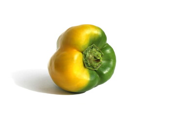 Ripening sweet pepper lies on a white isolated background.
