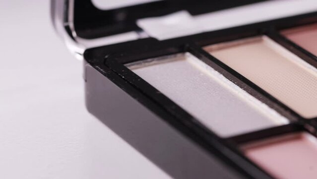 Modern trendy set of eye shadows on a white background. Soft texture of shadows with a powdery tint. High-quality cosmetics for girls, close-up, slider