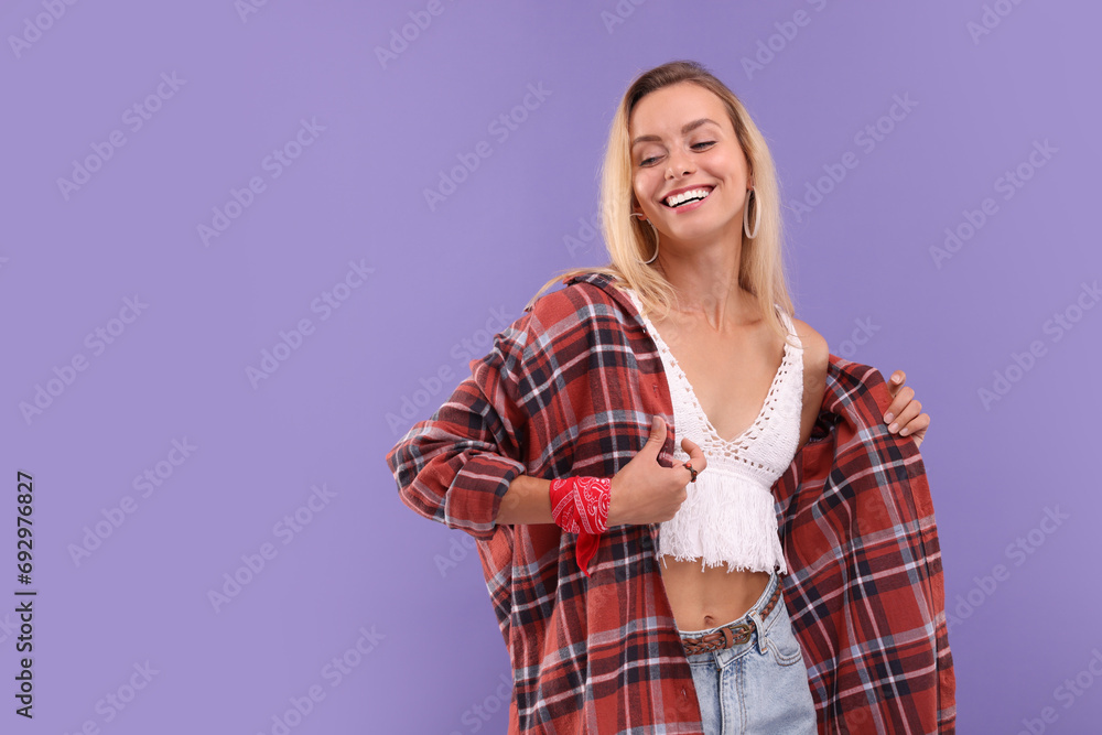 Wall mural Portrait of happy hippie woman on purple background. Space for text