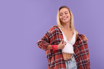 Portrait of happy hippie woman on purple background. Space for text