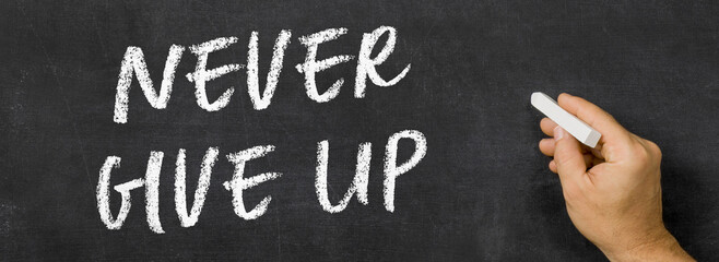  Text written on a blackboard -  Never give up