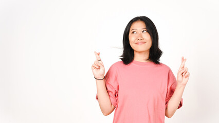 Young Asian woman in pink t-shirt doing Crossing Finger or Lucky Finger Gesture isolated on white...