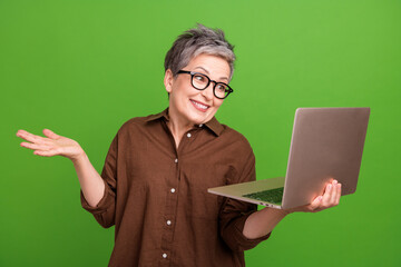 Portrait of funny clueless person dressed brown clothes in eyewear holding laptop shrug shoulders...