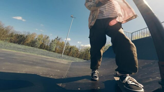 little girl learning to ride by Kick Scooter in a skate park, slow motion