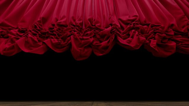 Red Austrian theater curtain gracefully rises and falls, its satin fabric catching the spotlight on stage.