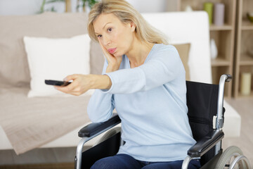 disabled woman bored watching tv in the living room