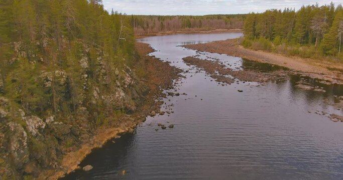 Aerial landscape view of Porttikoski rapids on Kitinen river in cloudy spring weather, Lapland, Sodankylä, Finland.