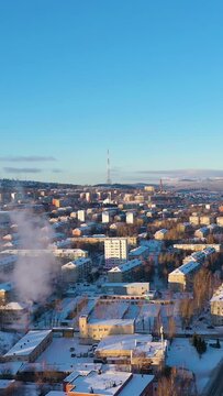 Zlatoust City on a Winter Sunny Day. Aerial View. Chelyabinsk Oblast. Russia. Drone Flies Forward. Vertical Video