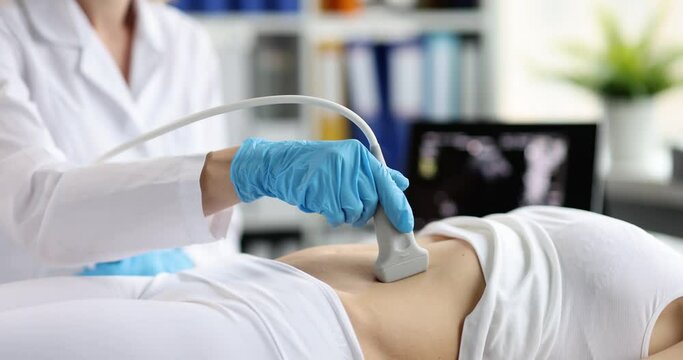The doctor makes an ultrasound of the abdominal cavity, close-up. Diagnostics of the pelvic organs, medical equipment