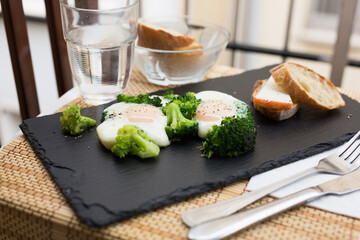 Breakfast of crumpled eggs with broccoli