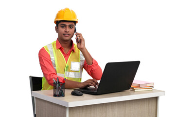 Indian male architect making phone call and working with laptop in office