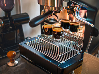 Professional espresso machine while preparing two espressos shot glass in a coffee shop. Espresso...