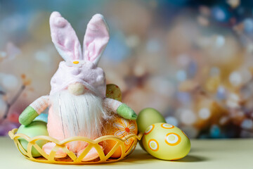 Easter eggs and rabbit with bright color decoration on light pastel background.