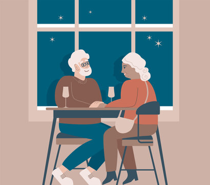 Romantic elderly couple sitting by the window in a cozy cafe. Smiling mature man and woman drinking wine together. Family talking spending time at cafeteria. Valentine day