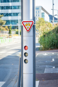 Red traffic light and M12 sign authorizing cyclists to cross the lights