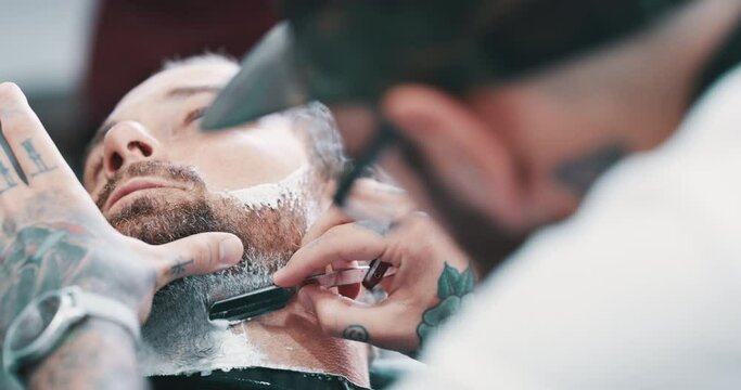 Hands, beard or shave with a barber and man closeup as a customer for luxury or professional service. Salon, shaving foam or hairdresser and a person grooming the face of a client with a minora blade
