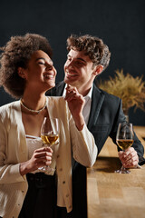 happy man smiling and looking at african american girlfriend during date on valentines day, romance