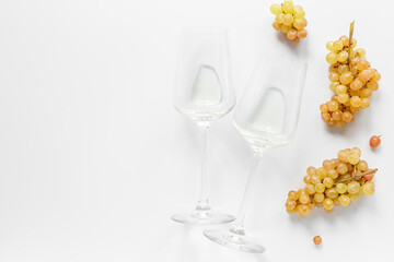 Two glasses of white wine with fresh grapes from the vineyard