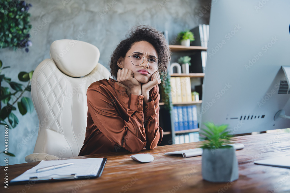 Poster Photo of unsatisfied minded pensive person sitting leather chair arms touch cheeks brainstorming modern office inside