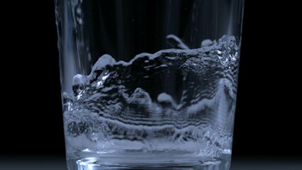 Pouring water into glass cup in ultra slow-motion at 1000 fps captured with high-speed camera