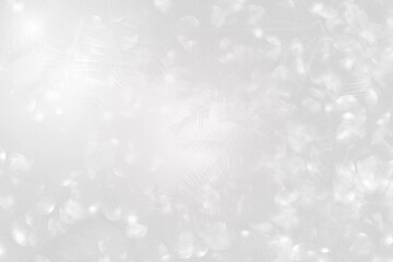 Abstract blurred shiny silver bokeh over blurred coconut tree background, holiday and festive...