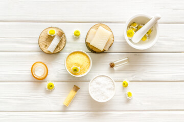 Herbal organic cosmetics products with chamomile flowers, top view